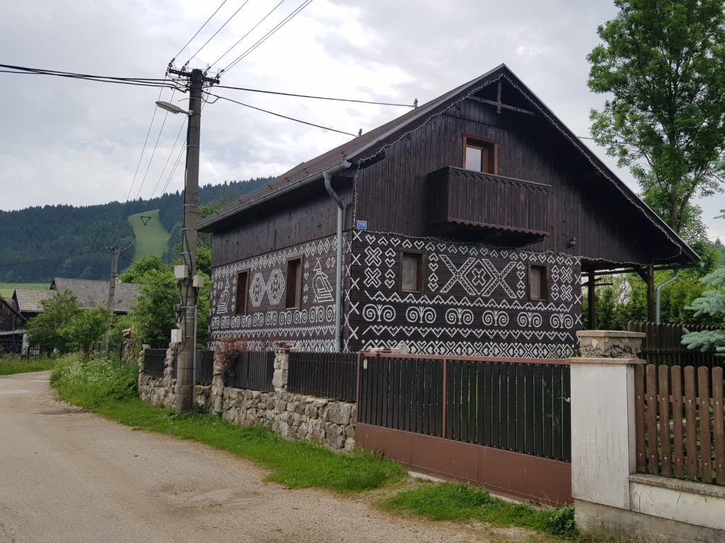 Čičmany is a tourist hot spot due to traditional houses with distinctive folk patterns. A copy of the patterns on a non-historical house.
